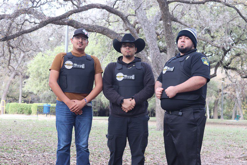 Three People Wearing Vests